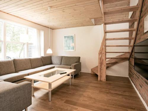 een woonkamer met een bank en een tafel bij Holiday home with sauna, whirlpool- Type1 in Blåvand
