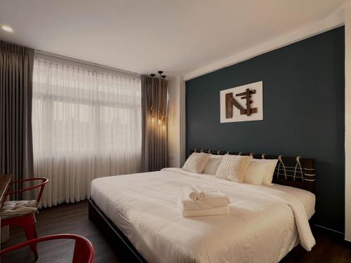 a bedroom with a large bed with a towel on it at Belivin'98 Sense of Pier Sathorn Residence in Bangkok