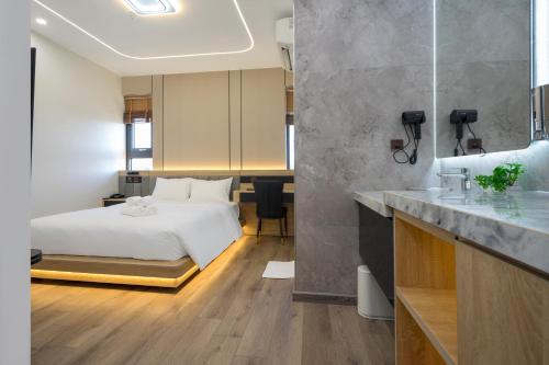 a hotel room with a bed and a bathroom at BBQ Hotel with Swimming Pool in Lạng Sơn in Lạng Sơn