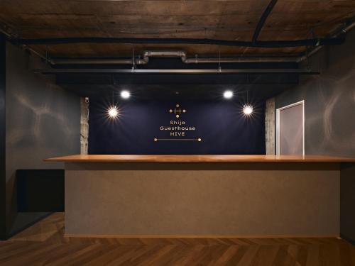 a counter in a room with a blue wall at Shijo Guesthouse HIVE in Kyoto