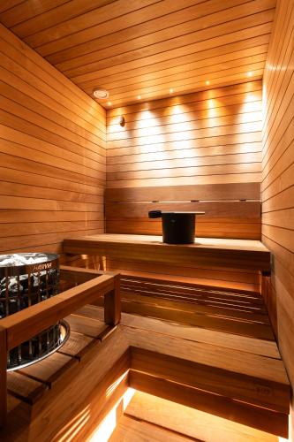 a sauna with wooden walls and a wooden floor at Cranberry C11 Levi Center incl 2 ski passes by Aavalevi in Levi