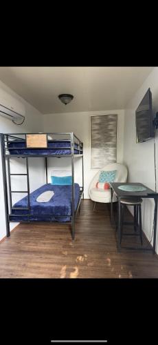 a room with two bunk beds and a table at Tiny house WiFi and parking in Miami
