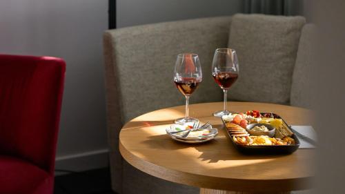 two glasses of wine and a tray of food on a table at Yallungah Boutique Hotel in Orange