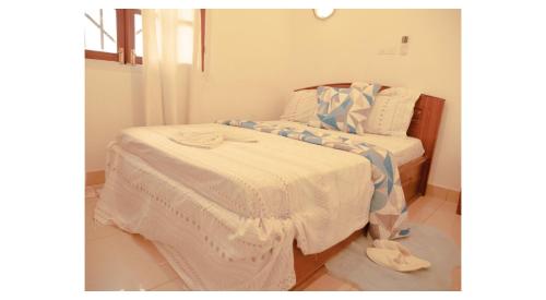 two beds in a room with towels on the floor at Résidence Suzanne in Brazzaville