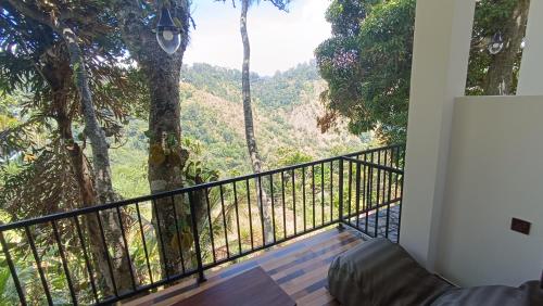 a balcony with a view of the mountains at Ameliora Hotel Ella in Ella