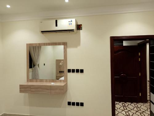 a bathroom with a mirror and a sink at Al Madinah Hotel in Al Madinah