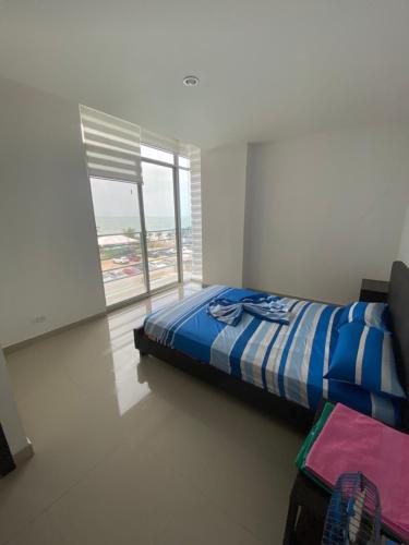 Postel nebo postele na pokoji v ubytování Departamento frente al mar edificio Arena Plaza
