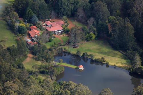 an aerial view of a house next to a lake at Forest Lodge Resort in Pemberton