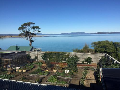 a garden with a view of a body of water at Absolute waterfront with a secret garden in Carlton