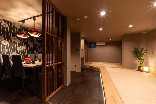 a kitchen and dining room with a table in a room at おやど紀伊国屋宝町 in Nagasaki