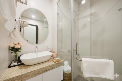 um banheiro branco com pia e chuveiro em Label6 coliving Quang Khanh em Hanói