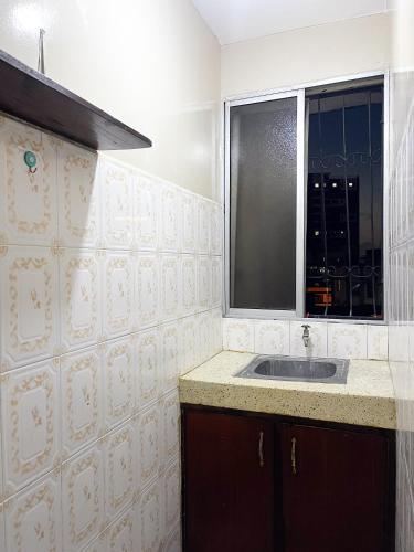 a bathroom with a sink and a window at Mombasa Town CBD Studio in Mombasa
