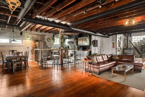 a living room with a couch and a table at Unique 2-BDR Historic Warehouse Loft with Terrace ! ! ! in Windsor