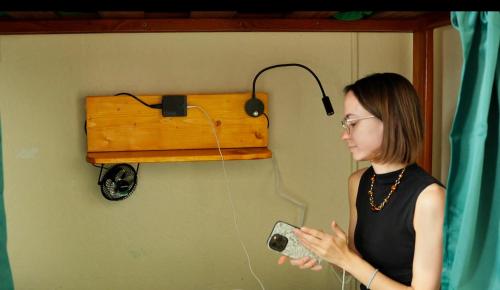 a woman standing in a room with a radio at Green Tortoise Hostel in San Francisco