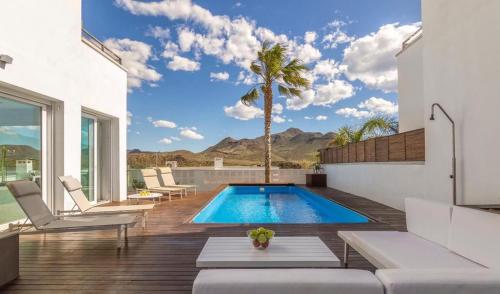 a swimming pool in the middle of a house at Villa de Luxe in San José