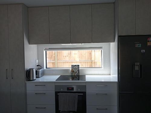 a kitchen with a sink and a window in it at Frederick Street Town house in Christchurch