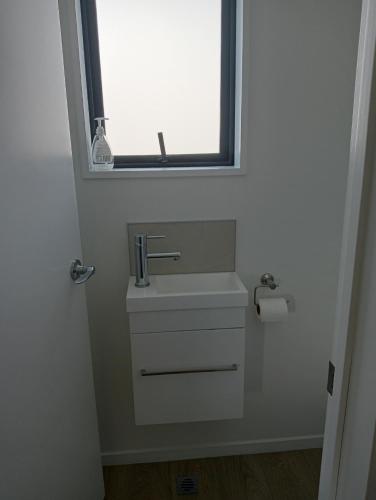 a bathroom with a sink and a window at Frederick Street Town house in Christchurch