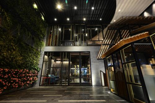an entrance to a building with glass doors and plants at The Chi Boutique Hotel in Hanoi