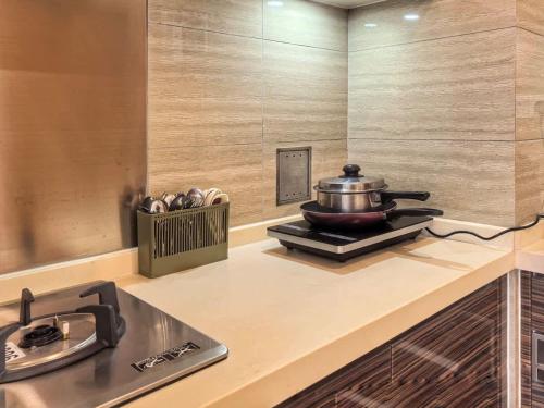 a kitchen with a stove and a pot on the counter at R&F Princess Cove 2BR, JB CIQ, Shopping Malls, by Good Life Homestay in Johor Bahru