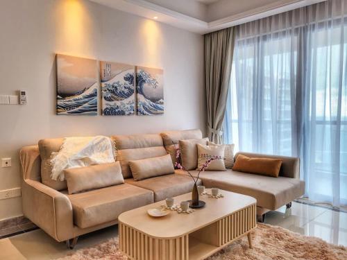 a living room with a couch and a table at R&F Princess Cove 3BR, Sea View, JB CIQ, by Good Life Homestay in Johor Bahru
