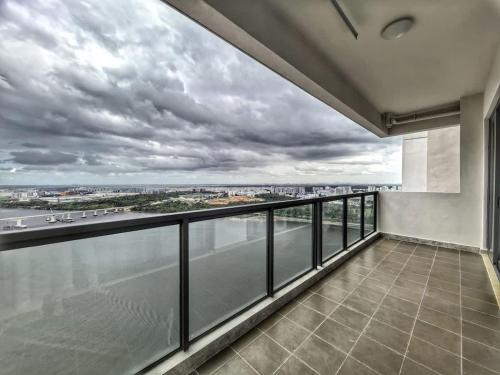 an apartment balcony with a view of the water at R&F Princess Cove 3BR, Sea View, JB CIQ, by Good Life Homestay in Johor Bahru