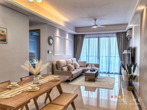 a living room with a couch and a table at R&F Princess Cove 2, 3BR, Sea View, JB CIQ, by Good Life Homestay in Johor Bahru