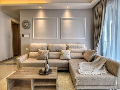 a living room with a couch and a table at R&F Princess Cove 2, 3BR, Sea View, JB CIQ, by Good Life Homestay in Johor Bahru