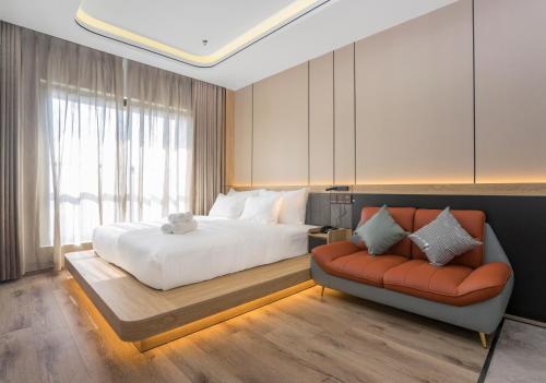 a bedroom with a large bed and a couch at BBQ Hotel with Swimming Pool in Lạng Sơn in Lạng Sơn