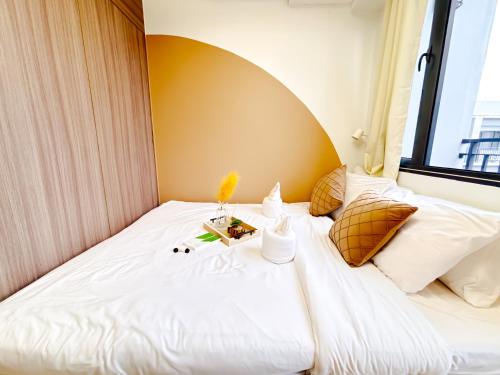 a bed with white sheets and pillows in a room at Casita Aroha SHORE 2 B02-19114 in Sampong