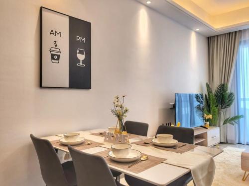 a dining room with a table and chairs at R&F Princess Cove 2BR Sea View Family Friendly in Johor Bahru