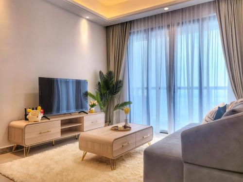 a living room with a flat screen tv and a couch at R&F Princess Cove 2BR Sea View Family Friendly in Johor Bahru