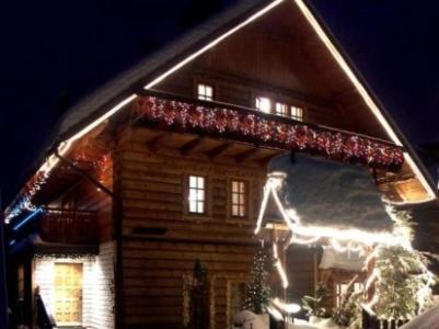 a house with christmas lights on the side of it at Willa Asia in Wisła