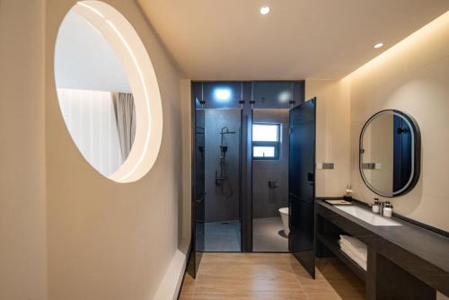 a bathroom with a sink and a mirror at Yunlanli Mountainside Homestay in Shangri-La
