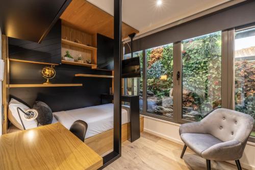 a room with a bunk bed and a table and a chair at D&S - Foz Riverside Apartment in Porto