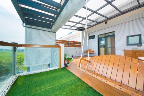 a porch with a swing on a house at 極簡旅行民宿 Simple Travel B&B in Wujie