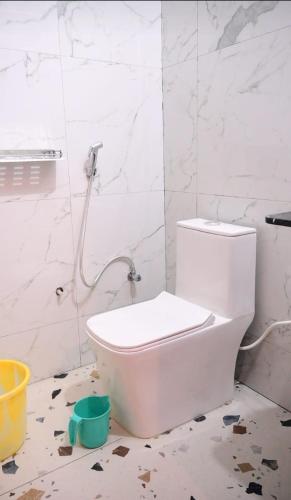 a white bathroom with a toilet in a room at Malwa resort in Chitrakoot