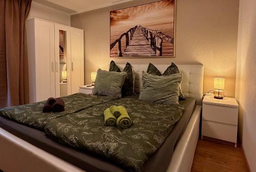 a bedroom with a bed with two hats on it at Luna & Stella Apartments, Sankt Englmar in Sankt Englmar