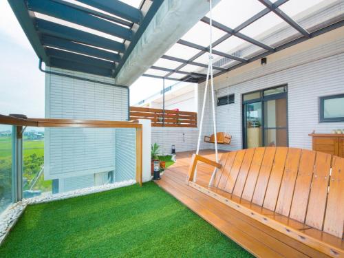 a porch with a swing on a house at 極簡旅行民宿 Simple Travel B&B in Wujie