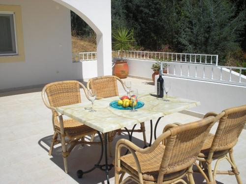 a table with a plate of fruit on a patio at Vivenda Pirilampo in Vila Nova de Poiares