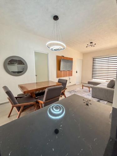 a living room with a table and chairs at Blue Sea Vallarta - Relax, Explore and Enjoy! in Los Algodones