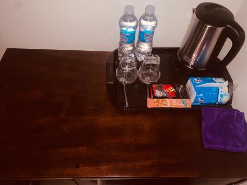 a table with two water bottles and glasses on it at Châu Home in Ninh Binh