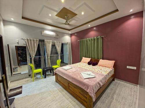 a bedroom with a bed and a desk in it at Hampi Palace in Hampi