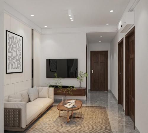 a living room with a couch and a table at Hai An Hotel Suites Ha Noi in Hanoi