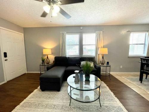 a living room with a black couch and a glass table at 1BD Condo HWY161-183 DFW South Irving - I67 in Sowers