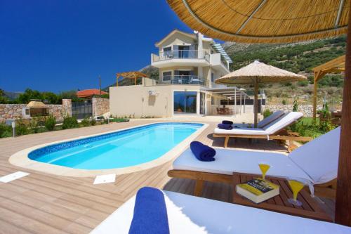 a villa with a swimming pool and a house at Kefalonia Horizon Villas in Ayia Evfimia