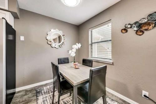 a dining room with a table with chairs and a mirror at 1BD Condo HWY161-183 DFW South Irving - I63 in Sowers