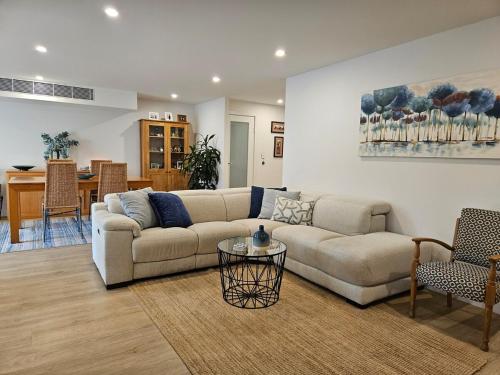 a living room with a couch and a table at South Cronulla Liandys in Cronulla