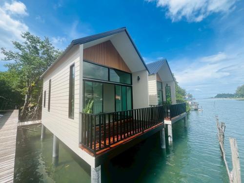 a house on a dock on a body of water at River view villa1 in Ban Map Khangkhao