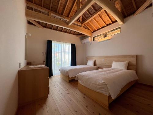 a bedroom with two beds and a wooden floor at Villa Muse Okinawa- Vacation STAY 43816v in Nago