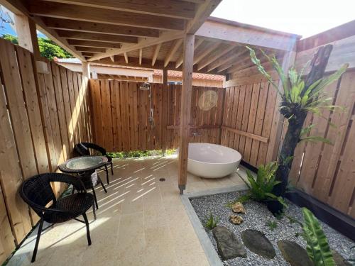 a bathroom with a bath tub in a wooden building at Villa Muse Okinawa- Vacation STAY 43816v in Nago